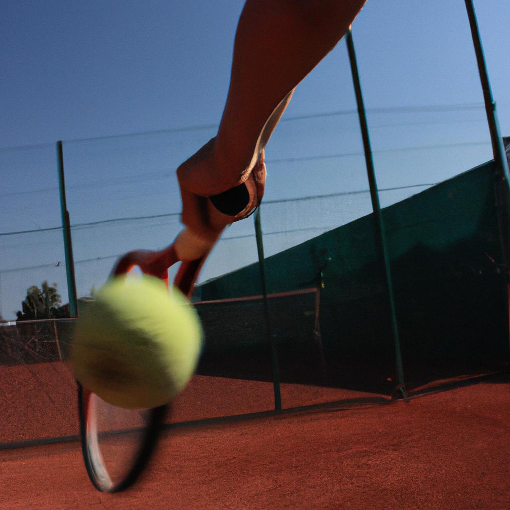 Person hitting a tennis ball