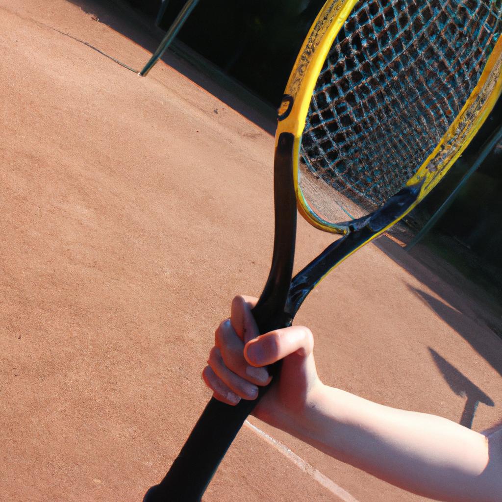 Person holding tennis racket, swinging